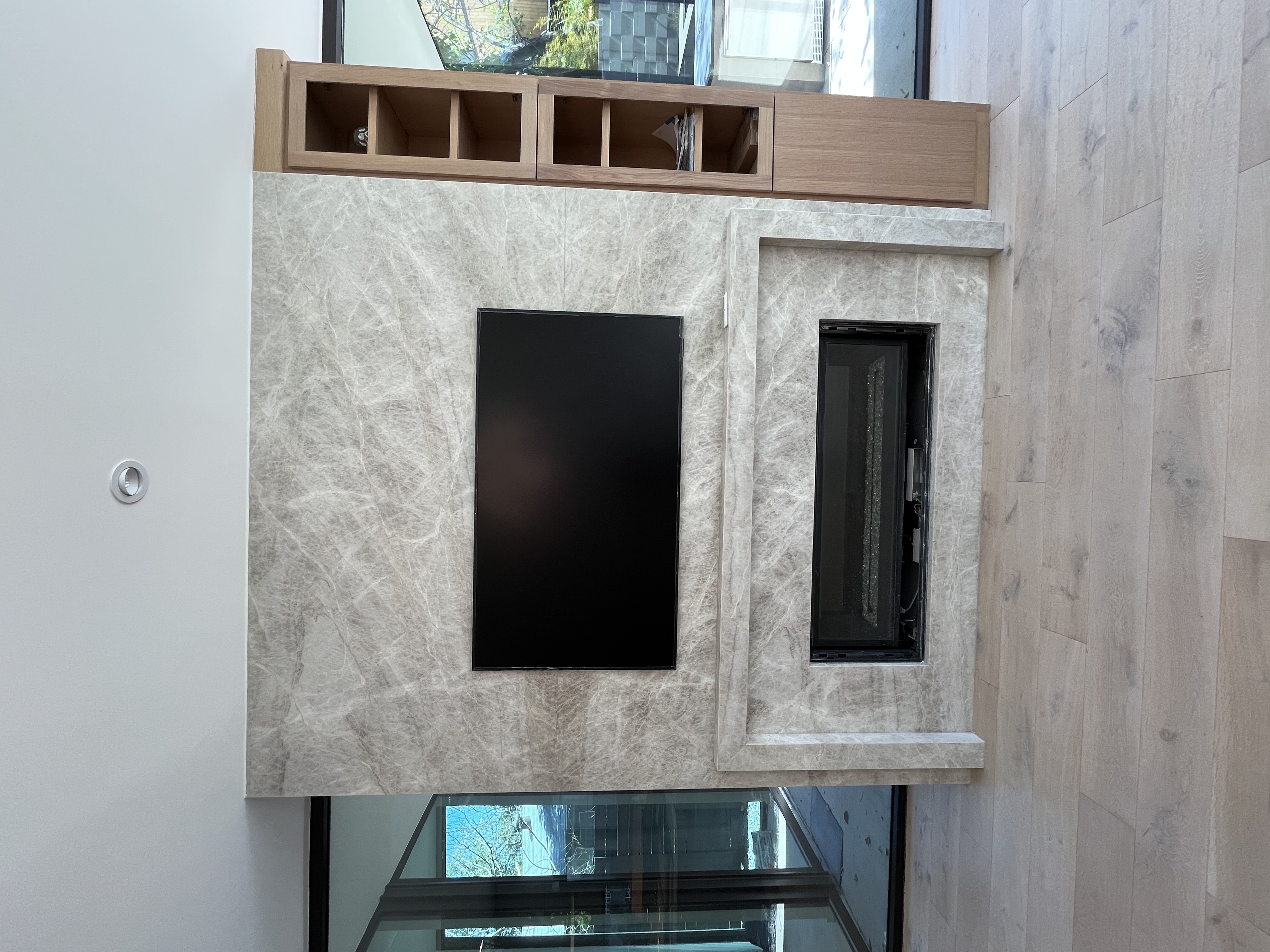 Frame TV installation process on marble fireplace wall
