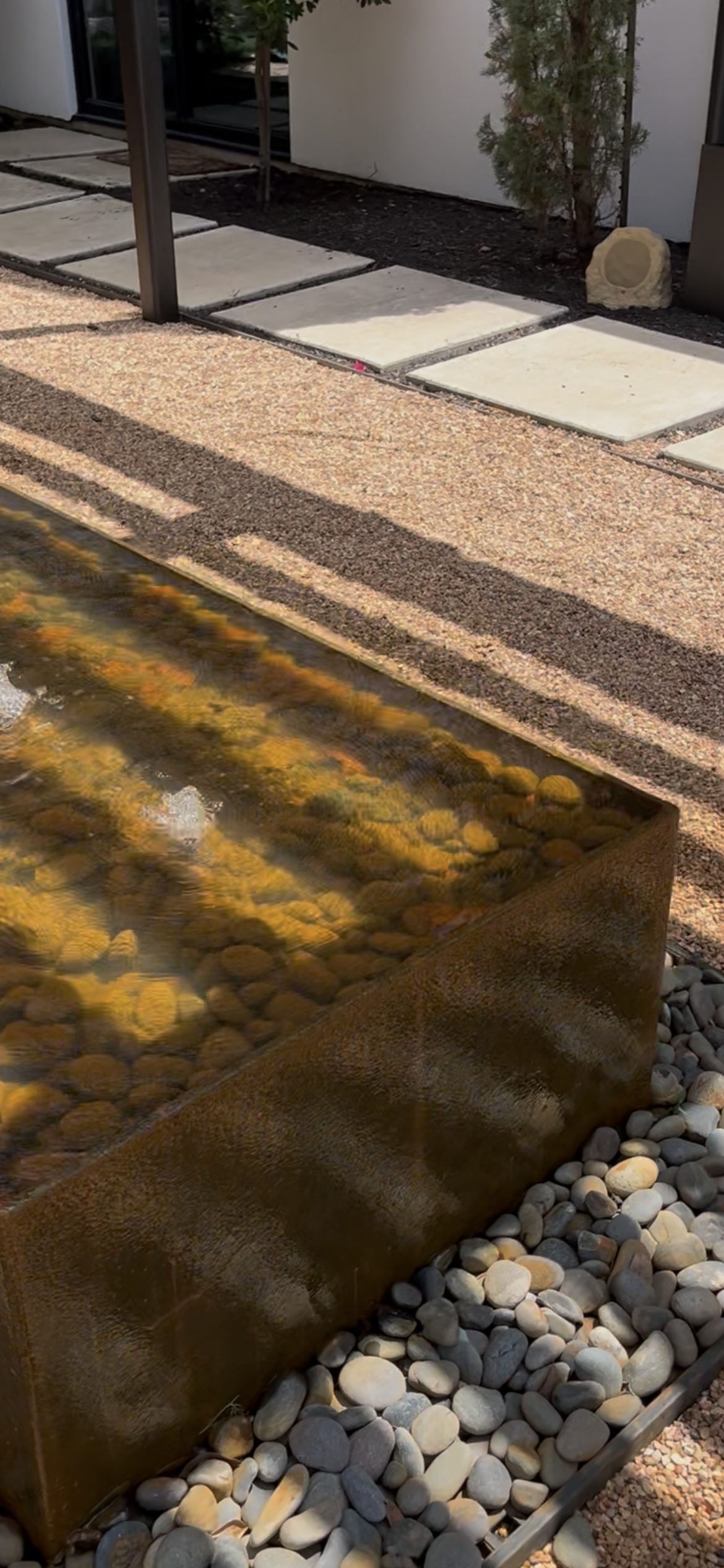 Outdoor audio installation with rock speaker near water feature San Antonio TX