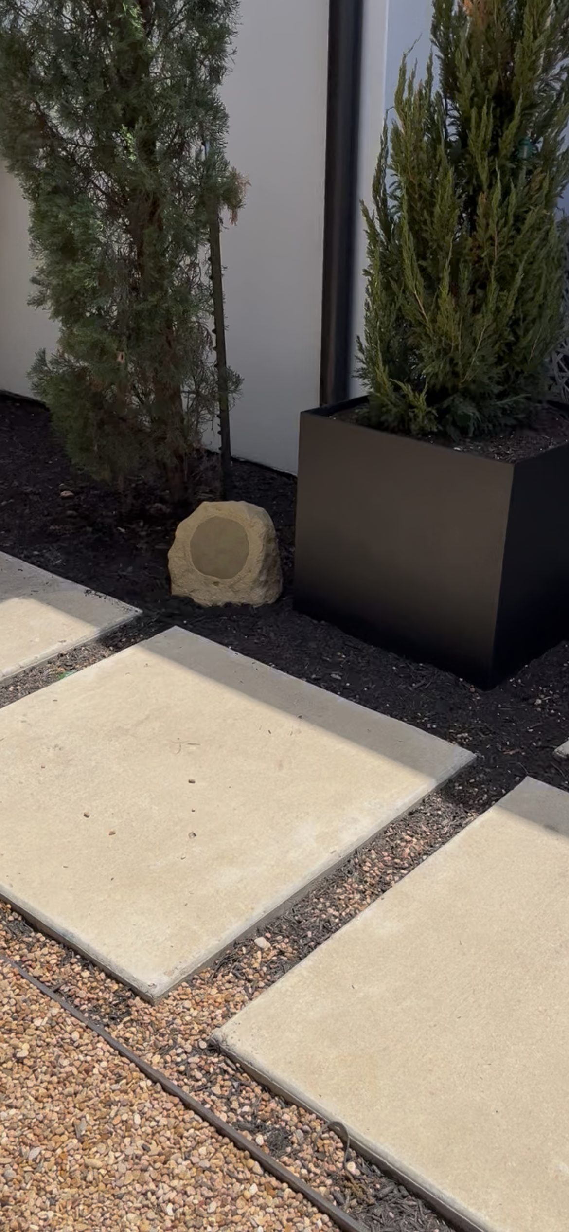 Rock speaker blending into mulch landscaping San Antonio TX